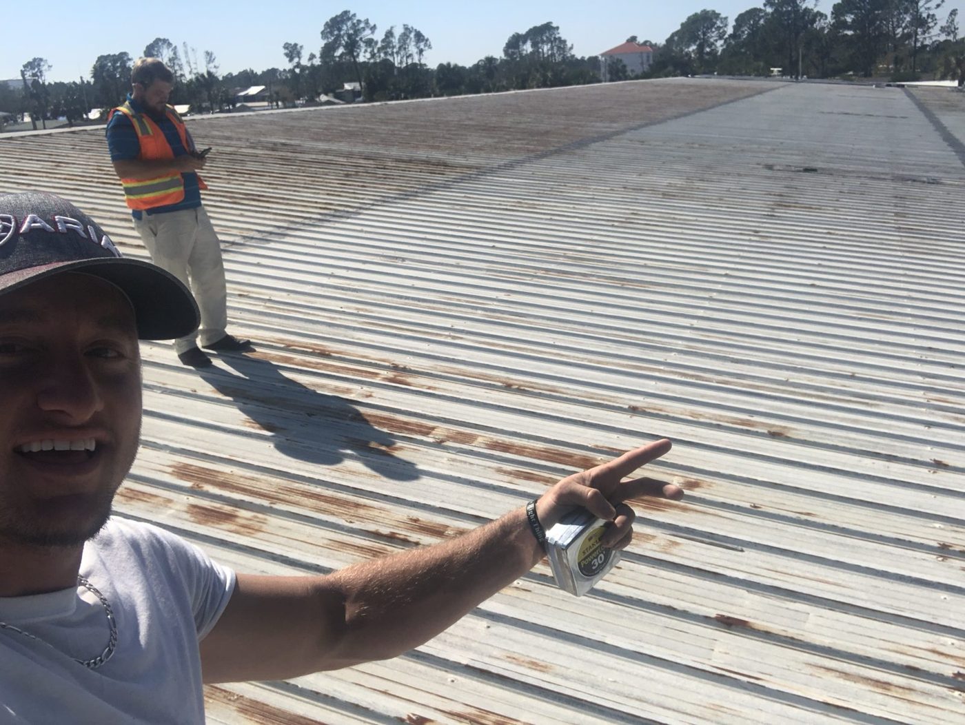 Our team documenting storm damage on a commercial metal roof.