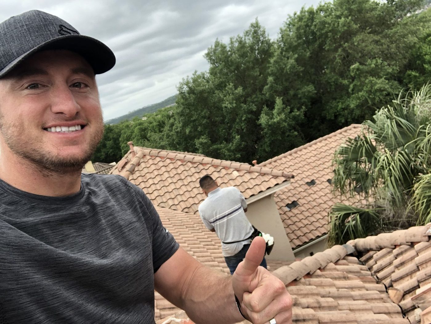 Inspecting a clay tile roof after a storm.